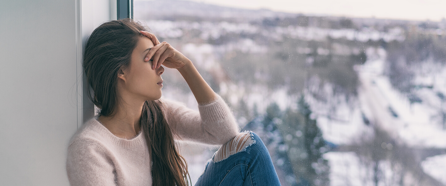 Sad woman with seasonal affective disorder in winter